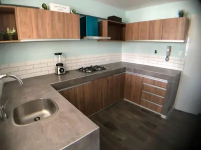 a kitchen with wooden cabinets and a sink in it at MLA apartments - 28 de Julio in Lima