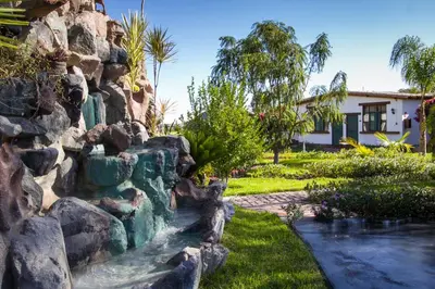 a rock retaining wall next to a garden at Casa Hacienda Nasca Oasis in Nazca