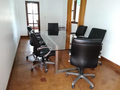 a conference room with a glass table and black chairs at Casa Hacienda Nasca Oasis in Nazca