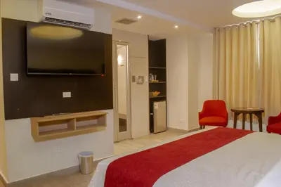 a hotel room with a bed with a flat screen tv at Verona Hotel Baños Turcos in Lima