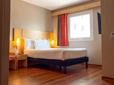 a hotel room with a bed and a window at ibis Lima Larco Miraflores in Lima