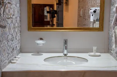 a bathroom with a sink and a mirror at Hotel Rojas Inn in Cusco