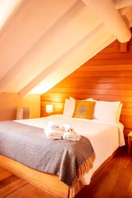 a bedroom with a bed with two towels on it at Nao Victoria Hostel in Cusco