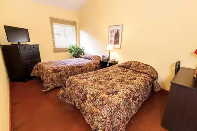 a hotel room with two beds and a television at LP Express Hotel Tarma in Tarma
