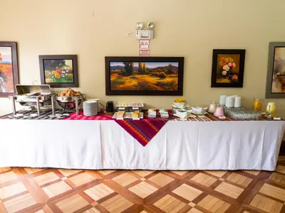 a white table with food on it in a room at LP Express Hotel Tarma in Tarma