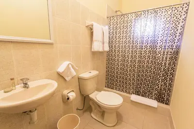 a bathroom with a toilet and a sink and a shower at LP Express Hotel Tarma in Tarma