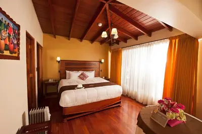 a bedroom with a large bed in a room at Hotel Mabey Urubamba in Urubamba