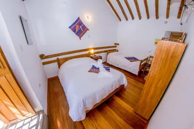 a bedroom with two beds in a room at Hostal El Grial in Cusco