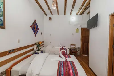 a room with two beds with skis on them at Hostal El Grial in Cusco