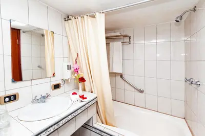 a bathroom with a sink and a shower and a tub at Hotel Sol del Oriente Cusco in Cusco