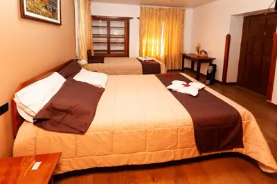 a hotel room with a large bed in a room at Hotel Sol del Oriente Cusco in Cusco