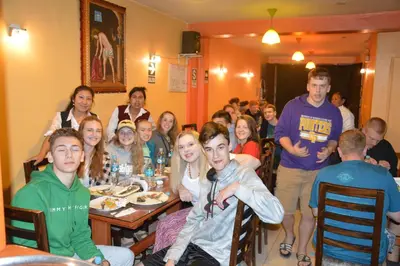 a group of people sitting at tables in a restaurant at Hostal Wasichay in Cusco
