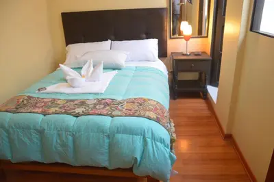 a bedroom with a bed with towels on it at Hostal Wasichay in Cusco