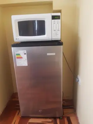 a microwave sitting on top of a refrigerator at Hostal Wasichay in Cusco