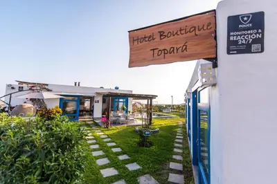 a sign for a hotel building with a restaurant at Topara Hotel Boutique in San Vicente de Cañete