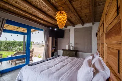 a bedroom with a bed and a large window at Topara Hotel Boutique in San Vicente de Cañete