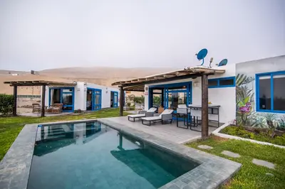 a house with a swimming pool in the yard at Topara Hotel Boutique in San Vicente de Cañete
