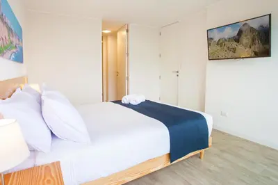 a bedroom with a large white bed with white pillows at Lima Walking Apartments - Central Miraflores in Lima