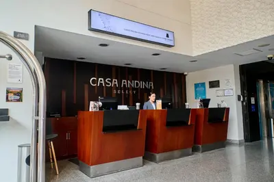 a woman sitting at a cash counter in a lobby at Casa Andina Select Miraflores in Lima