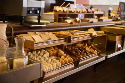 a bakery counter with various types of bread and pastries at Casa Andina Select Miraflores in Lima