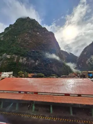 a train station with a mountain in the background at Mapi Garden's Machupicchu in Machu Picchu