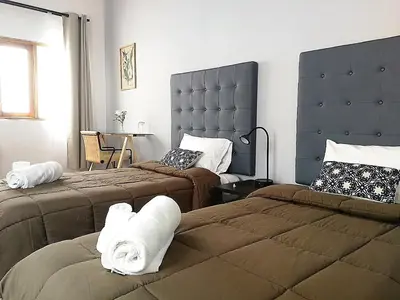 a hotel room with two beds with towels on them at Belma Boutique Bed and Breakfast in Lima