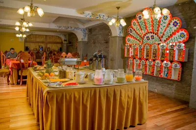 a long table with food and drinks on it at Hotel Warari in Cusco