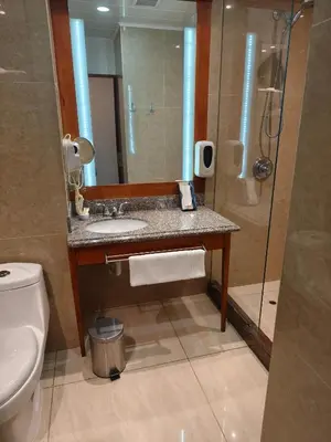 a bathroom with a sink and a toilet and a mirror at La Luna Inn in Lima