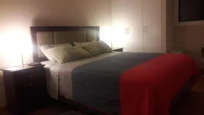 a bedroom with a large bed with two lamps at MIRAFLORES LUXURY PLACE POOL GYM 2BD in Lima