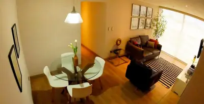 a living room with a glass table and a couch at MIRAFLORES LUXURY PLACE POOL GYM 2BD in Lima