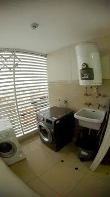a small bathroom with a sink and a washing machine at MIRAFLORES LUXURY PLACE POOL GYM 2BD in Lima