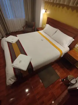 a large bed in a hotel room at Picos House MachuPicchu in Machu Picchu