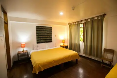 a bedroom with a yellow bed and a window at Casa de Baraybar in Lima