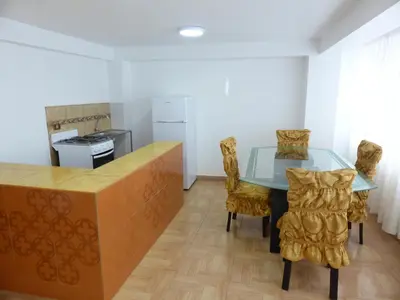 a kitchen with a glass table and chairs at Apartment Samana House in Cusco