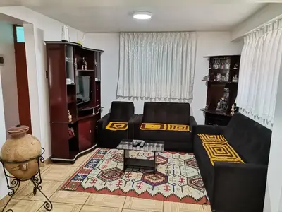 a living room with a black couch and a table at Apartment Samana House in Cusco