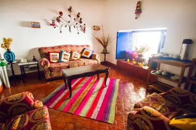 a living room with a couch and a rug at Rumi Wasi in Cusco