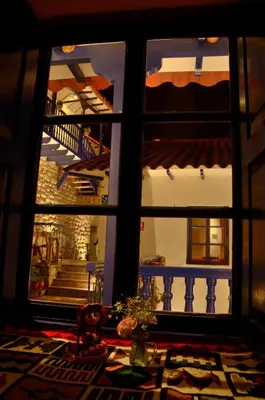 a view through a window of a room with a staircase at Rumi Wasi in Cusco