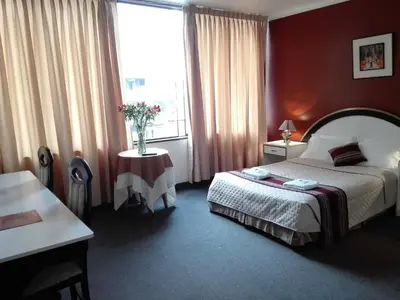 a hotel room with a bed and a large window at Los Q'eros in Lima