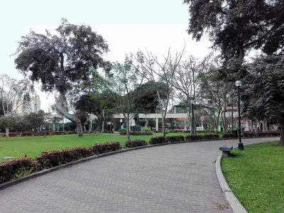 a park with a bench and grass and trees at Los Q'eros in Lima