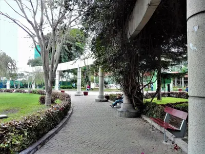 a group of people sitting on benches in a park at Los Q'eros in Lima