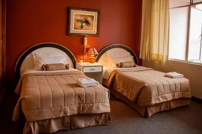 a hotel room with two beds and a window at Los Q'eros in Lima