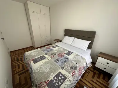 a bedroom with a bed with a quilt on it at VIVE Apartments Cusco in Cusco