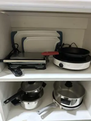 a shelf with pots and pans in a kitchen at VIVE Apartments Cusco in Cusco