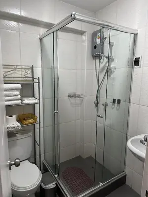 a bathroom with a shower with a toilet and a sink at VIVE Apartments Cusco in Cusco