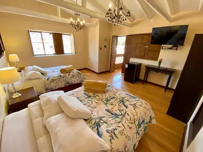a living room with two beds and a couch at Cusco Hotel Boutique in Cusco