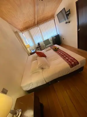 a bedroom with a large white bed with a window at Cusco Hotel Boutique in Cusco