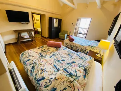 a living room with a bed and a flat screen tv at Cusco Hotel Boutique in Cusco