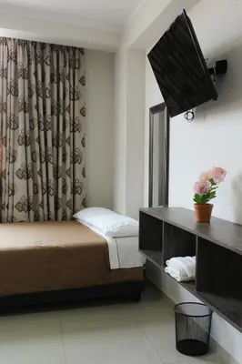 a hotel room with a bed and a television at Gran Caral Hotel in Barranca