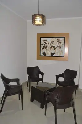a room with chairs and a table and a painting at Gran Caral Hotel in Barranca