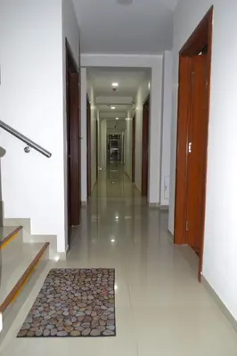 a hallway of a building with a rug on the floor at Gran Caral Hotel in Barranca